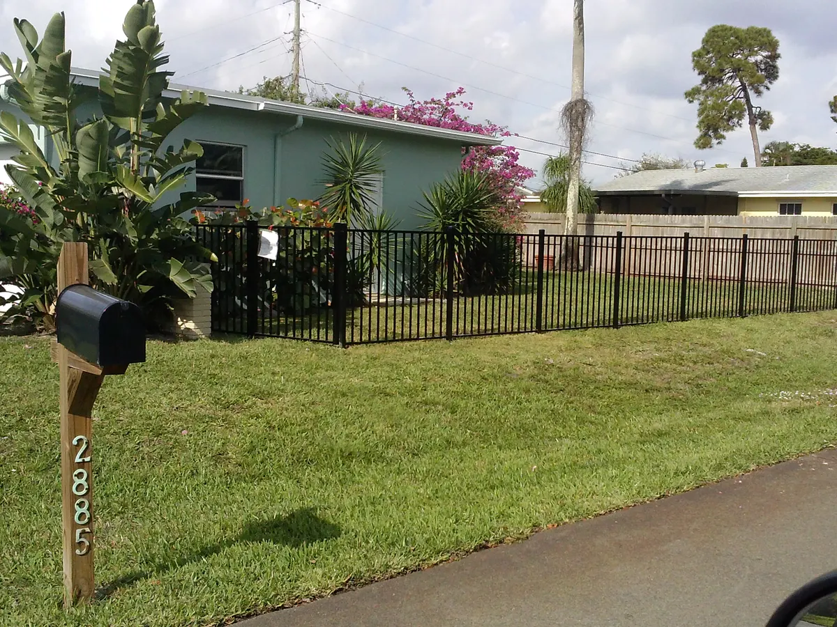 4ft black aluminum post and rail fence on residential property