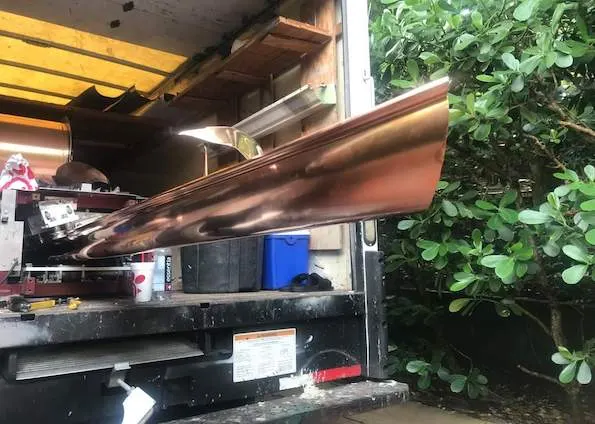 Copper gutter being custom fabricated by The Gutter Pros for a Treasure Coast home