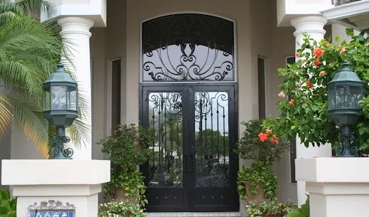 Custom ornamental iron front door with decorative scrollwork by Allied Fence